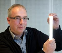 Coen Liedenbaum, Innovation Area Manager Lighting for Philips Research, with the prototype 200 lumens per watt tube LED in the lab, now the world's most efficient LED lighting on a system, "real world" level that does not compromise on light quality. (Royal Philips Electronics)